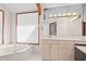 Bathroom with a bathtub, double vanity, and large mirror at 2942 Seabrook Island Rd, Seabrook Island, SC 29455