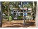 Back of house with large windows and deck, surrounded by lush trees at 2942 Seabrook Island Rd, Seabrook Island, SC 29455