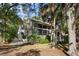 Two story house with large windows and wrap around deck, surrounded by trees at 2942 Seabrook Island Rd, Seabrook Island, SC 29455