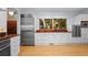White kitchen with stainless steel appliances and wood floors at 2942 Seabrook Island Rd, Seabrook Island, SC 29455