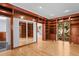 Library with hardwood floors, built-in bookshelves, and a large mirror at 2942 Seabrook Island Rd, Seabrook Island, SC 29455