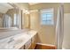 Bathroom with double vanity, shower/tub combo, and window at 307 Pimpernel St, Summerville, SC 29483