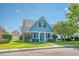Quaint light blue house with a front porch and neatly kept lawn at 307 Pimpernel St, Summerville, SC 29483