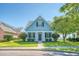 Adorable light blue house with a front porch and well-manicured lawn at 307 Pimpernel St, Summerville, SC 29483