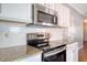 Stainless steel appliances and granite countertops in this kitchen at 307 Pimpernel St, Summerville, SC 29483