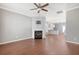 Open living room with hardwood floors, fireplace, and kitchen view at 307 Pimpernel St, Summerville, SC 29483