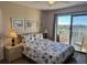 Cozy bedroom with balcony access and ocean views at 3701 Dock Site Rd # 205, Edisto Beach, SC 29438
