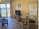 Small dining area with glass table and four chairs at 3701 Dock Site Rd # 205, Edisto Beach, SC 29438