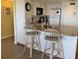 Kitchen with granite countertops, white cabinets, and breakfast bar seating at 3701 Dock Site Rd # 205, Edisto Beach, SC 29438