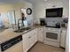 Well-equipped kitchen featuring granite countertops and white cabinets at 3701 Dock Site Rd # 205, Edisto Beach, SC 29438
