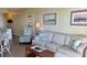 Living room with hardwood floors, comfortable seating, and coastal-themed decor at 3701 Dock Site Rd # 205, Edisto Beach, SC 29438