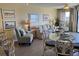 Bright living room with hardwood floors, comfy seating, and a glass dining table at 3701 Dock Site Rd # 205, Edisto Beach, SC 29438
