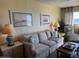 Relaxing living room with a beige sofa and coastal decor at 3701 Dock Site Rd # 205, Edisto Beach, SC 29438