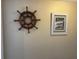 Wall features nautical decor, including a ship's wheel and coastal artwork at 3701 Dock Site Rd # 205, Edisto Beach, SC 29438