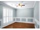 Formal dining room with hardwood floors, wainscoting, and plantation shutters at 5382 Westchester Pl, North Charleston, SC 29418