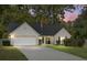 House exterior at dusk showcasing a two-car garage and landscaping at 5382 Westchester Pl, North Charleston, SC 29418