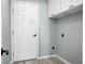 Bright laundry room with white cabinets and vinyl flooring at 5382 Westchester Pl, North Charleston, SC 29418