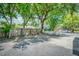 Gravel parking area with wooden fence and mature trees at 78 Sans Souci St # B, Charleston, SC 29403