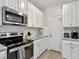 Modern kitchen with white cabinets, granite counters, and stainless steel appliances at 8968 Cat Tail Pond Rd, Summerville, SC 29485