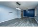 Dining room with gray floors, blue and gray walls, and a modern light fixture at 100 Hounds Run, Goose Creek, SC 29445