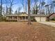 Brick ranch house with attached two-car garage and mature trees at 105 Gambels Ln, Summerville, SC 29485