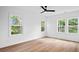 Bright bedroom with three large windows and a modern ceiling fan at 1137 Happyland Blvd, Mount Pleasant, SC 29466