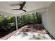 Covered patio with ceiling fan offers an outdoor space to enjoy the wooded backyard at 1137 Happyland Blvd, Mount Pleasant, SC 29466