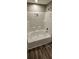 Bathroom features a bathtub with shower and updated flooring at 126 Addison Rd, Harleyville, SC 29448