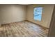 Bedroom with wood-look floors and large window at 126 Addison Rd, Harleyville, SC 29448