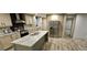 Modern kitchen with island, stainless steel appliances, and wood cabinets at 126 Addison Rd, Harleyville, SC 29448
