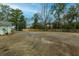 Large backyard with gravel area, wooden fence, and basketball hoop at 1420 Old Whitesville Rd, Moncks Corner, SC 29461