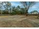 Large backyard with gravel area and wooden fence at 1420 Old Whitesville Rd, Moncks Corner, SC 29461