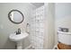 Bathroom with pedestal sink, ruffled shower curtain, and toilet at 1420 Old Whitesville Rd, Moncks Corner, SC 29461