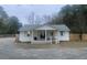 Charming white house with a front porch and fenced yard at 1420 Old Whitesville Rd, Moncks Corner, SC 29461