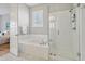 Spa-like bathroom with soaking tub, walk-in shower, and marble flooring at 1617 Bowsprit Ct, Mount Pleasant, SC 29466