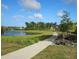 Concrete walking path winds along pond and homes at 1617 Bowsprit Ct, Mount Pleasant, SC 29466