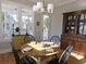 Charming dining area with a round wooden table, four chairs, and a hutch at 1617 Bowsprit Ct, Mount Pleasant, SC 29466
