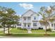 Two-story white house with light blue accents, a front porch, and a landscaped lawn at 1617 Bowsprit Ct, Mount Pleasant, SC 29466