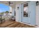 Charming front porch with light blue door and rocking chair at 1617 Bowsprit Ct, Mount Pleasant, SC 29466