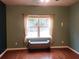 Bedroom with window, neutral walls, and hardwood floors at 1708 Indaba Way, Charleston, SC 29414
