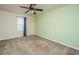 This carpeted bedroom features a ceiling fan and a window with blinds and a curtain at 1708 Indaba Way, Charleston, SC 29414