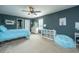 This furnished bedroom features gray walls, a ceiling fan, a bed, and other furniture at 1708 Indaba Way, Charleston, SC 29414