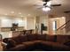 Open living room and kitchen with brown sectional sofa and granite counters at 1708 Indaba Way, Charleston, SC 29414