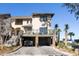 Two-story townhome with attached garage and deck, offering charming curb appeal at 1915 Marsh Oak Ln, Seabrook Island, SC 29455