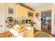 Bright kitchen with yellow cabinets, modern appliances, and breakfast bar at 1915 Marsh Oak Ln, Seabrook Island, SC 29455