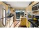 Well-equipped kitchen featuring yellow cabinets and modern appliances at 1915 Marsh Oak Ln, Seabrook Island, SC 29455