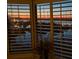 Sunset view over marina from window with shutters at 1915 Marsh Oak Ln, Seabrook Island, SC 29455
