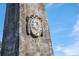 Close-up of an ornate stone monument featuring a carved relief portrait at 2038 Ironstone Aly # 17, Charleston, SC 29407