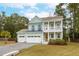 Charming two-story house with a green exterior, two car garage and front porch at 2155 Provolone Ln, Johns Island, SC 29455