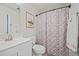 Clean bathroom with white vanity, shower/tub combo, and geometric patterned shower curtain at 2262 Folly Rd # 2-K, Charleston, SC 29412